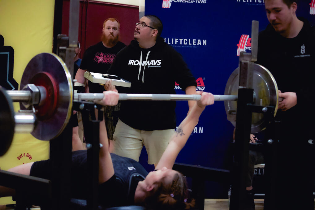 Coach Trujillo judging a bench press attempt at a USA Powerlifting meet