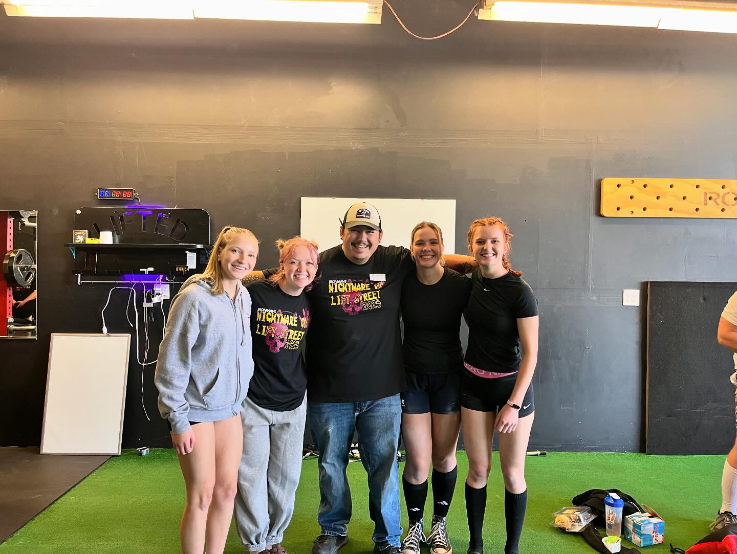 Coach Trujillo with Iron Mavericks athletes in the gym