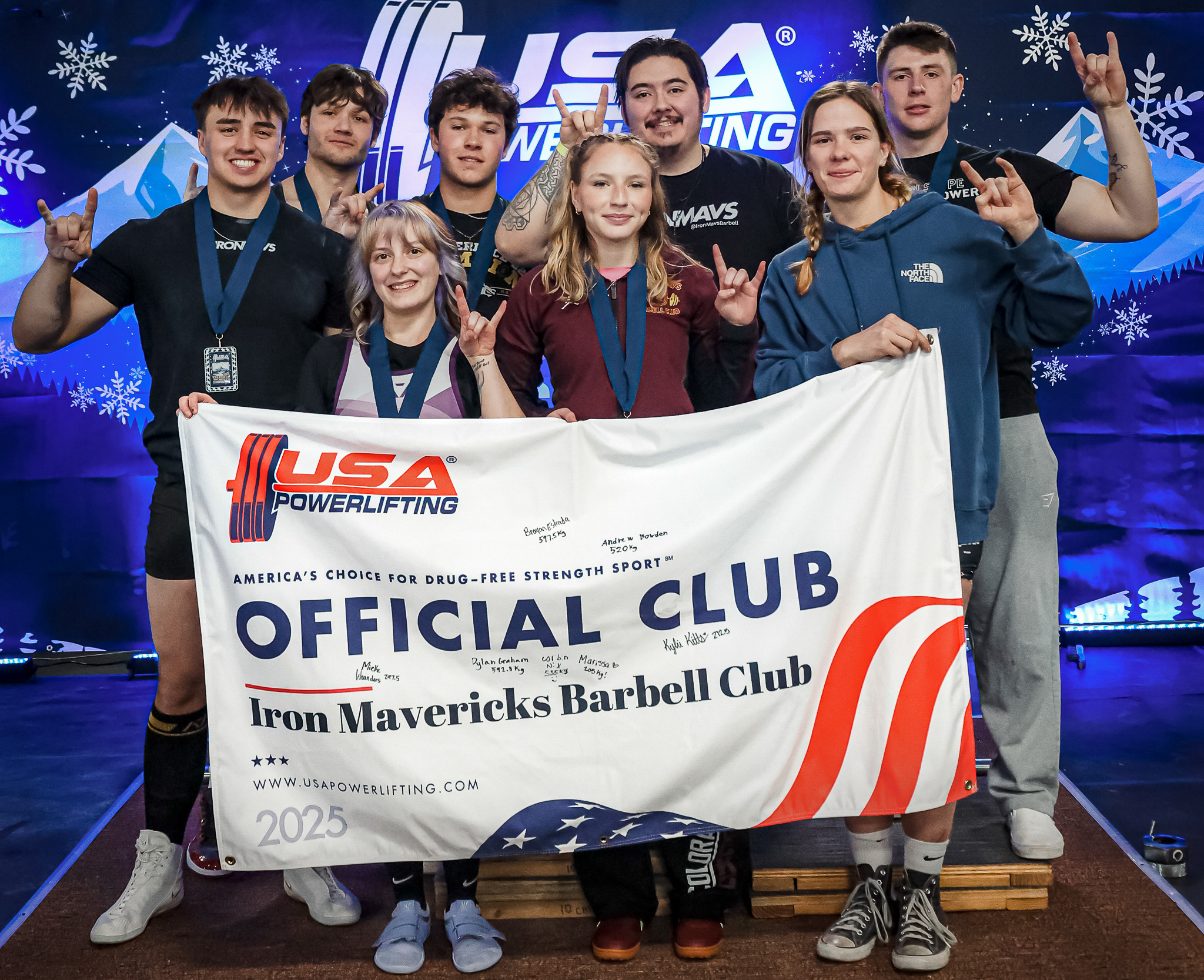 The Iron Mavericks Barbell Club holding their USA Powerlifting Official Club banner